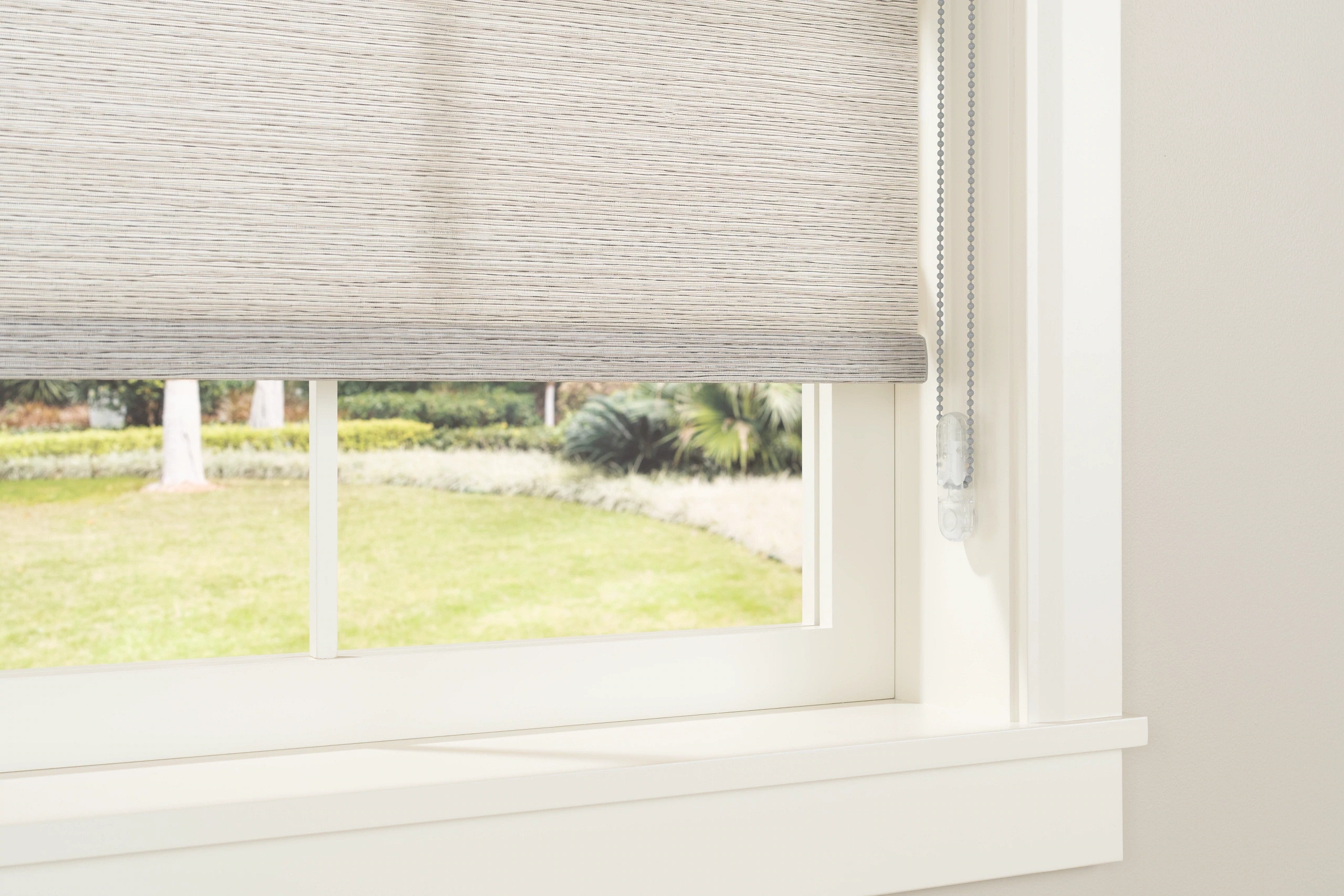 A continuous-loop control and safety tensioner for Graber roller shades.