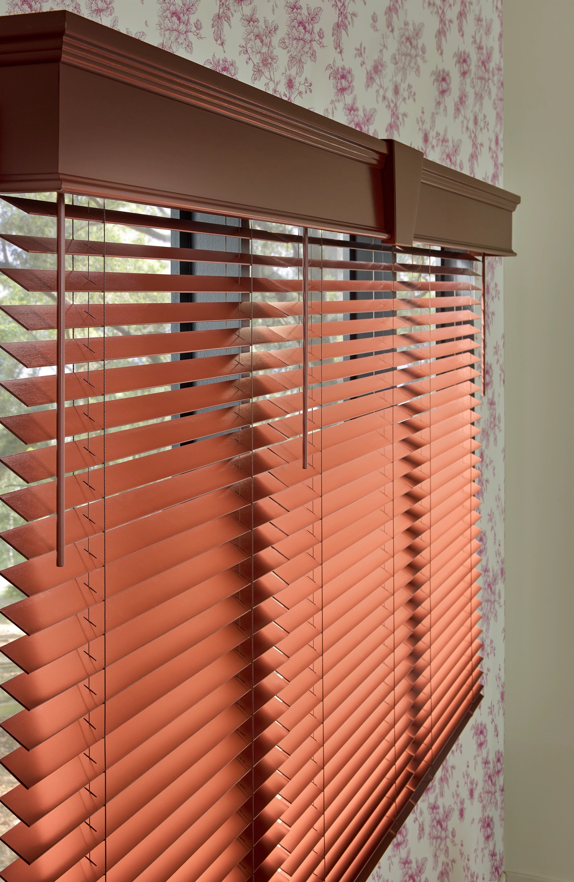 Close-up of Graber custom wood blinds in a terracotta finish.